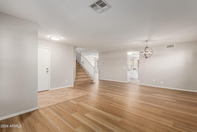 interior space with light wood-type flooring and a notable chandelier