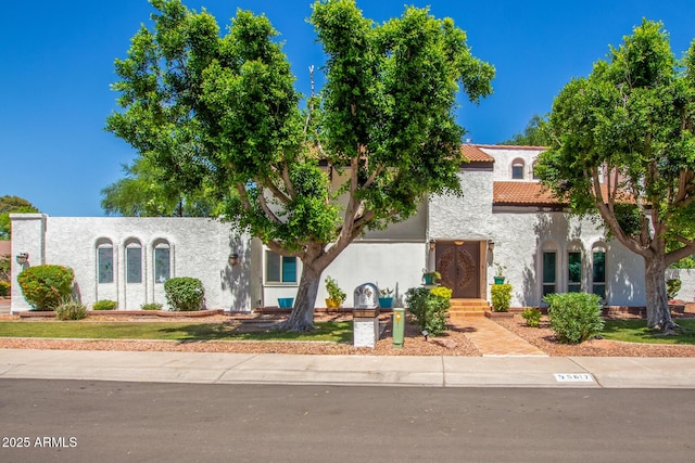 view of front of home with stucco siding and a tiled roof