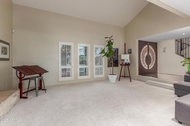 sitting room featuring carpet, stairway, and high vaulted ceiling