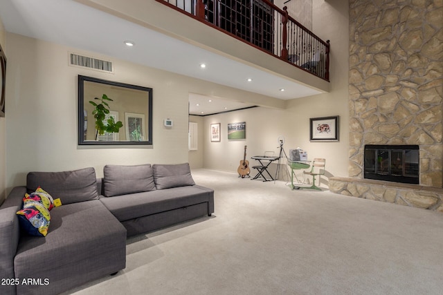 living room with carpet flooring, a fireplace, recessed lighting, and a towering ceiling