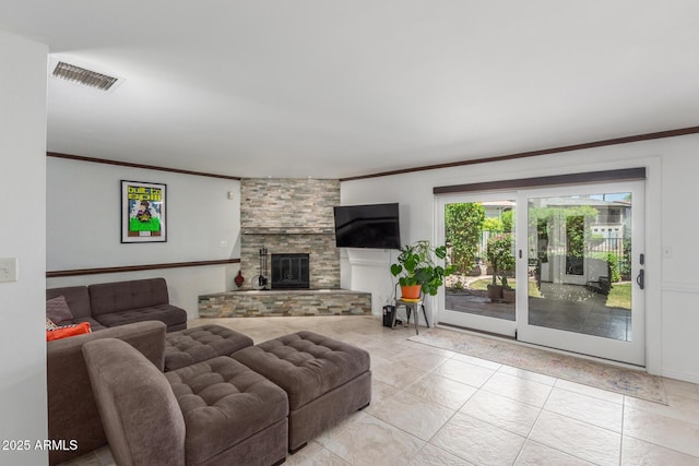 living area featuring ornamental molding, light tile patterned floors, and a large fireplace