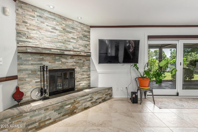 living area featuring a large fireplace and baseboards