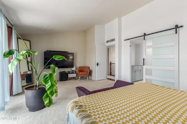 bedroom featuring a barn door, carpet flooring, and lofted ceiling