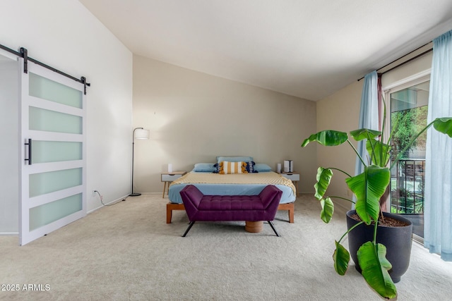 carpeted bedroom with lofted ceiling and a barn door