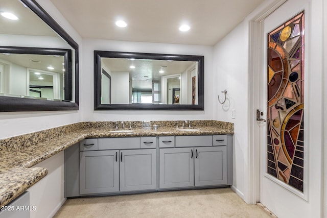 bathroom featuring double vanity and recessed lighting