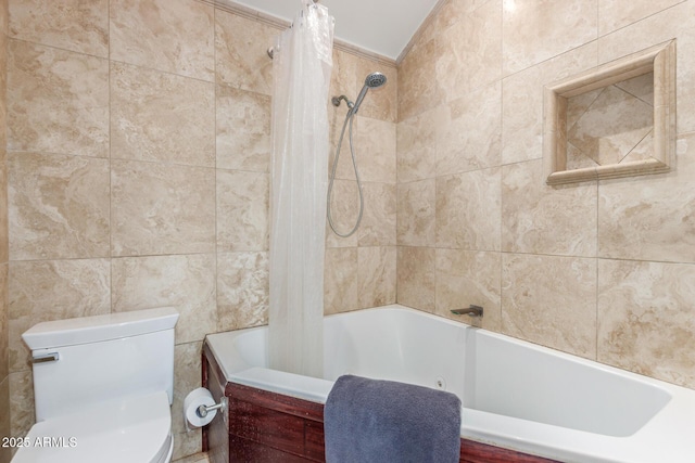 bathroom with shower / tub combo, tile walls, and toilet