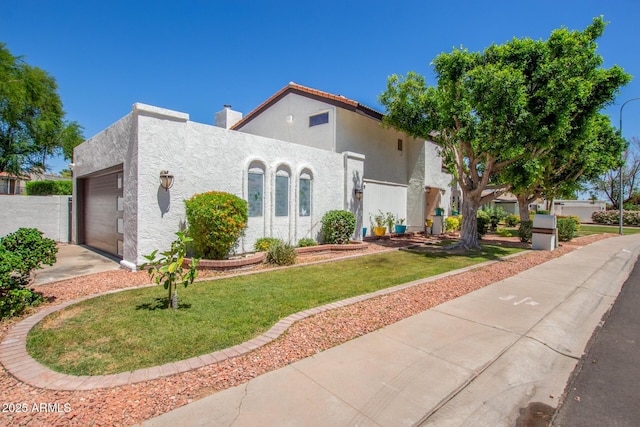 mediterranean / spanish-style house featuring a garage, stucco siding, driveway, a front yard, and a chimney