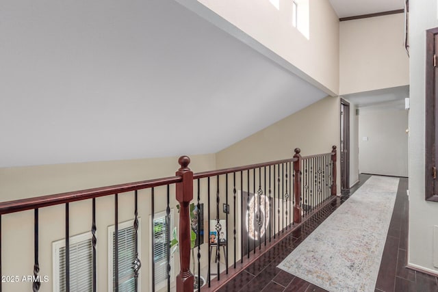 corridor with dark wood finished floors and a high ceiling