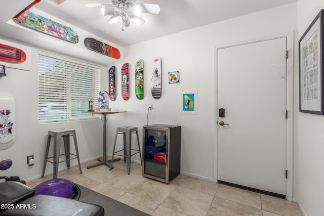 miscellaneous room featuring a ceiling fan and baseboards