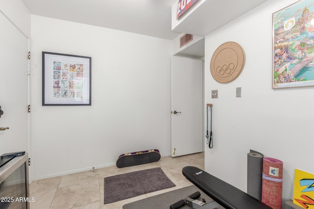 workout area featuring light tile patterned floors