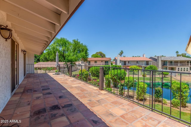 view of patio featuring a residential view and a balcony