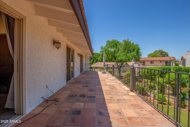 view of patio featuring a balcony