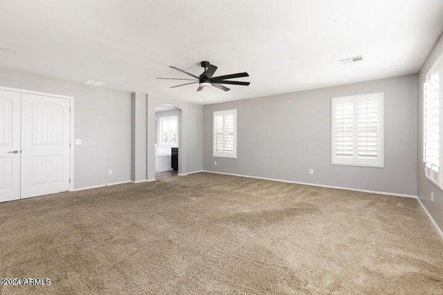 carpeted empty room with ceiling fan