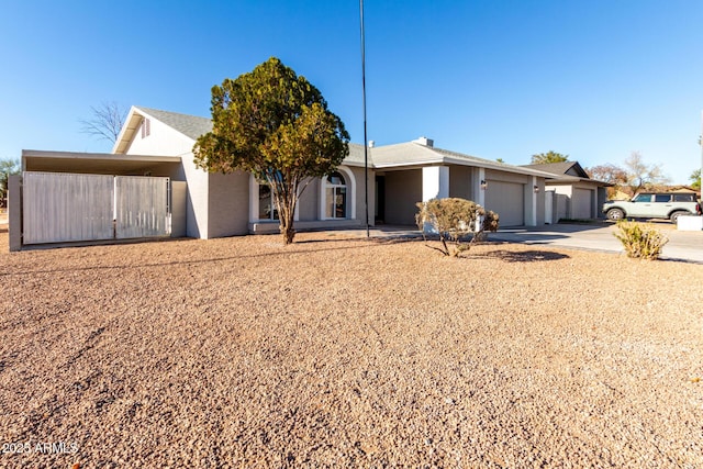 single story home featuring a garage and a carport