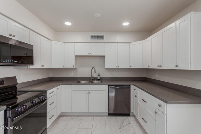 8508 W Clarendon Ave W, Phoenix, AZ 85037 - kitchen featuring a sink, dark countertops, visible vents, marble finish floor, and appliances with stainless steel finishes
