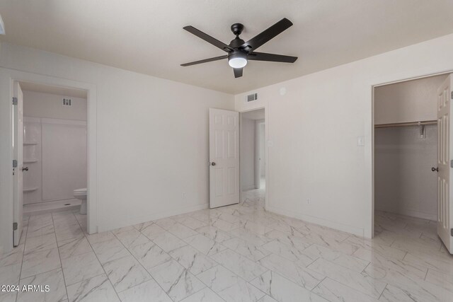 8508 W Clarendon Ave W, Phoenix, AZ 85037 - unfurnished bedroom with ensuite bath, visible vents, marble finish floor, and a walk in closet