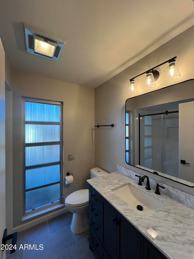 bathroom featuring tile patterned flooring, vanity, and toilet