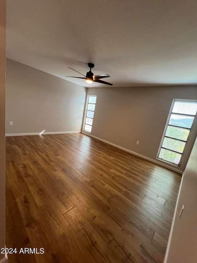 spare room with hardwood / wood-style floors and ceiling fan