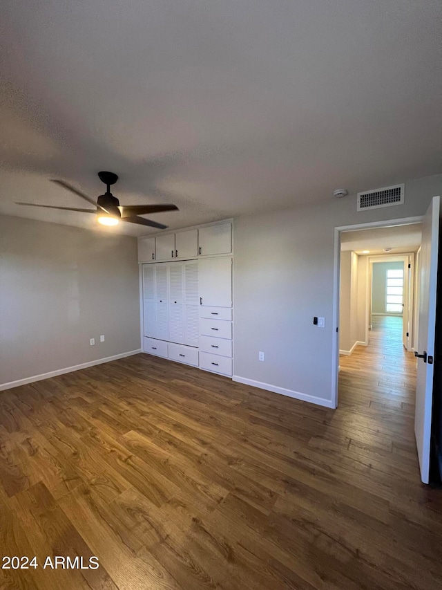 unfurnished bedroom featuring a closet, ceiling fan, and hardwood / wood-style floors