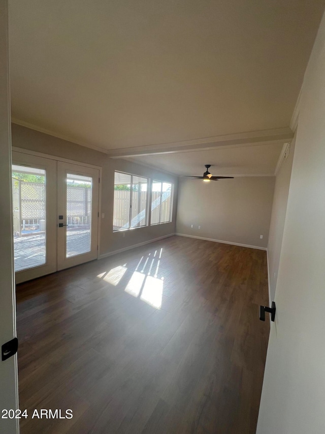 spare room featuring crown molding, plenty of natural light, wood-type flooring, and ceiling fan