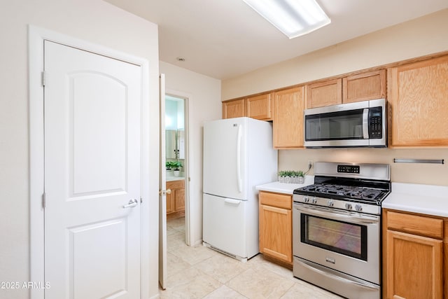 kitchen with light brown cabinets and stainless steel appliances