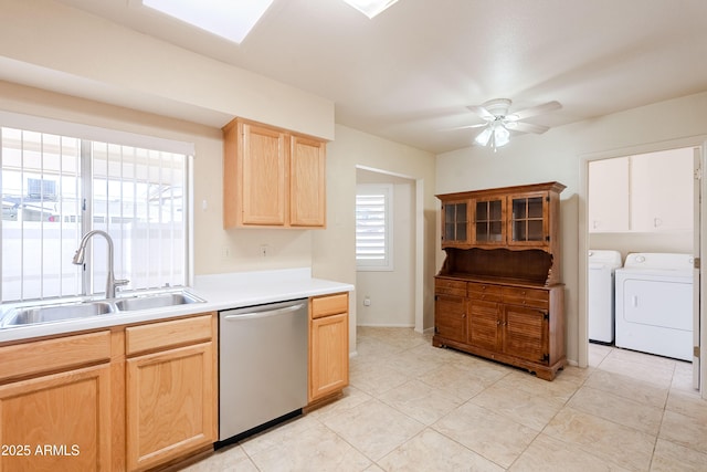 kitchen with light brown cabinetry, dishwasher, ceiling fan, sink, and separate washer and dryer