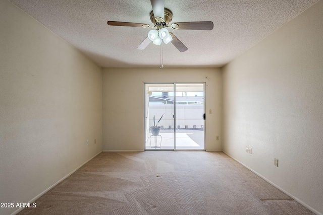 spare room featuring a textured ceiling, light colored carpet, and ceiling fan