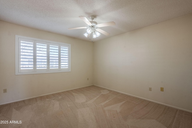 carpeted spare room with ceiling fan and a textured ceiling