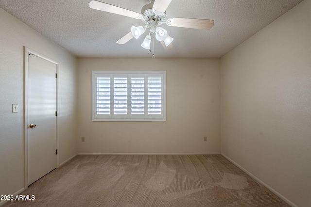 spare room with light carpet, a textured ceiling, and ceiling fan