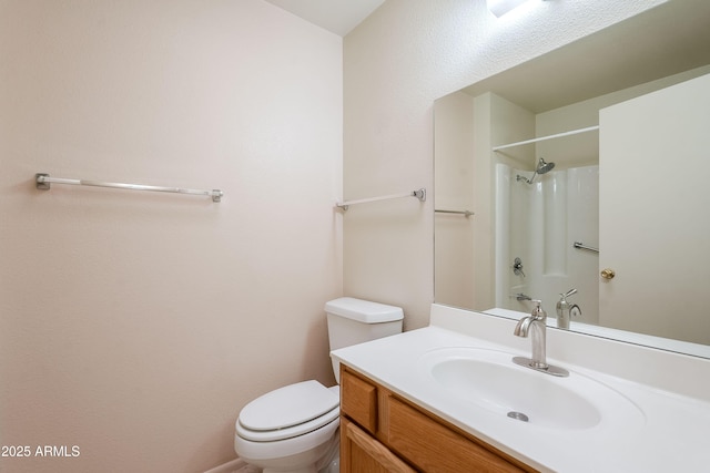 bathroom featuring vanity, toilet, and walk in shower