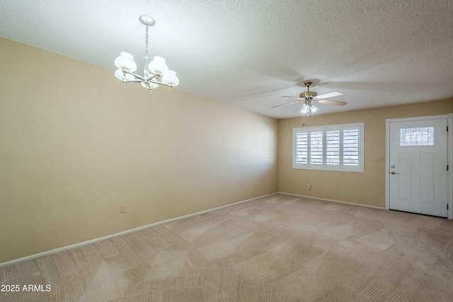 interior space with a textured ceiling and ceiling fan with notable chandelier