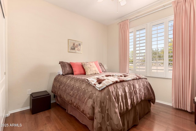 bedroom featuring wood finished floors and baseboards