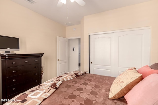 bedroom featuring a closet, lofted ceiling, and a ceiling fan