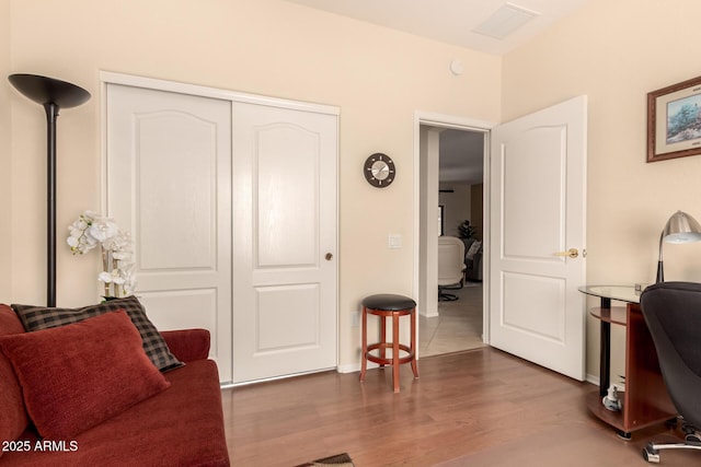 interior space with wood finished floors, visible vents, and baseboards