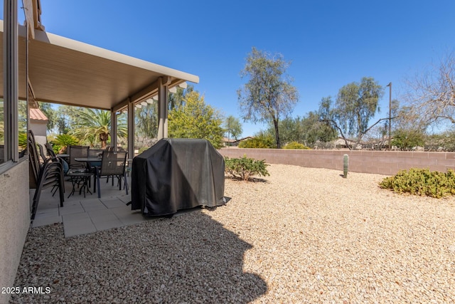 view of yard with a patio, a fenced backyard, and outdoor dining space