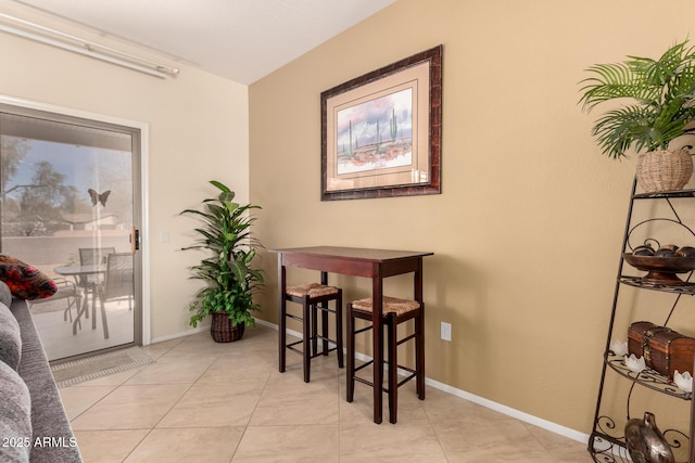 dining area with light tile patterned floors and baseboards