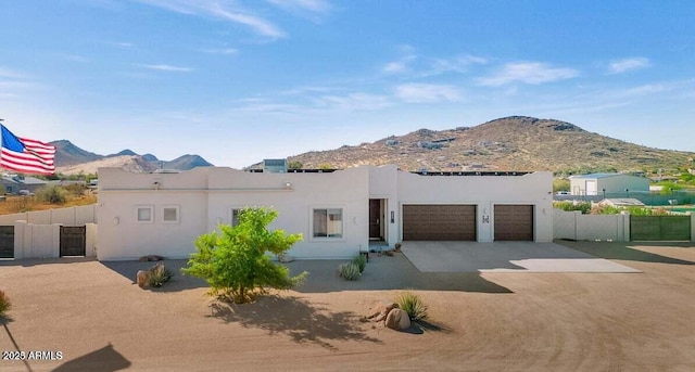 view of front of property with a garage and a mountain view