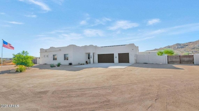 adobe home featuring a garage and a mountain view