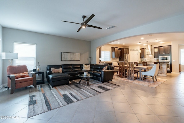 tiled living room with ceiling fan