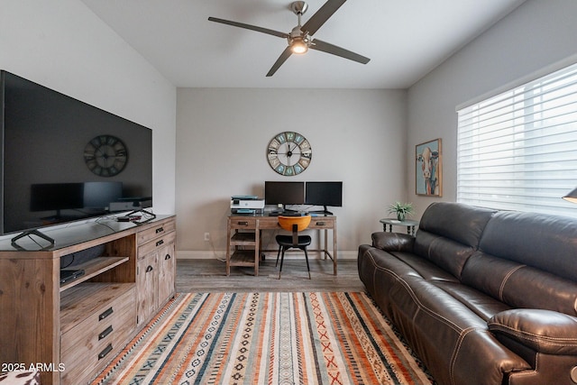 living room featuring wood-type flooring and ceiling fan