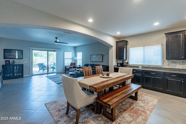 tiled dining area featuring ceiling fan