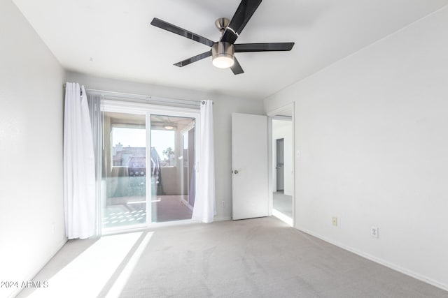 unfurnished room featuring light carpet and ceiling fan