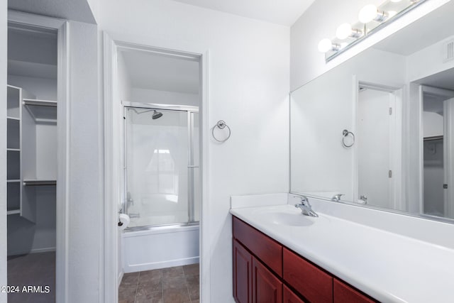 bathroom featuring vanity and bath / shower combo with glass door