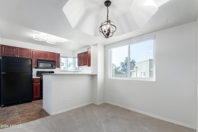 kitchen with light carpet, kitchen peninsula, hanging light fixtures, black appliances, and a notable chandelier