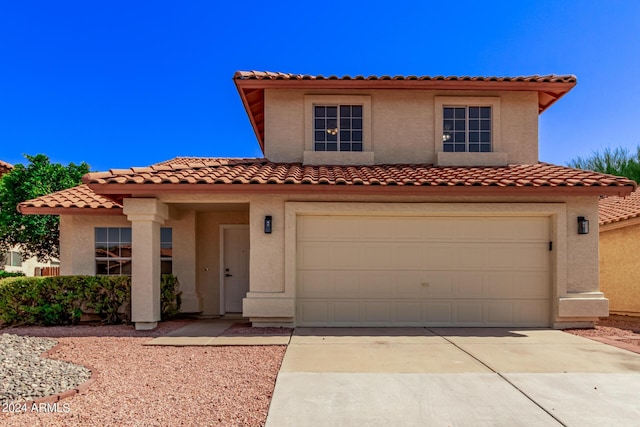 mediterranean / spanish home with a garage