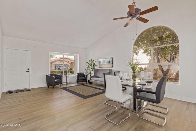 dining area featuring light hardwood / wood-style floors, high vaulted ceiling, and ceiling fan