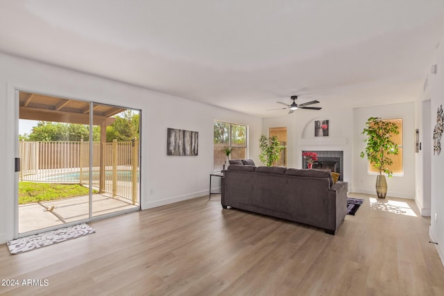 living room featuring light hardwood / wood-style floors and ceiling fan