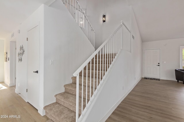 stairs with hardwood / wood-style flooring