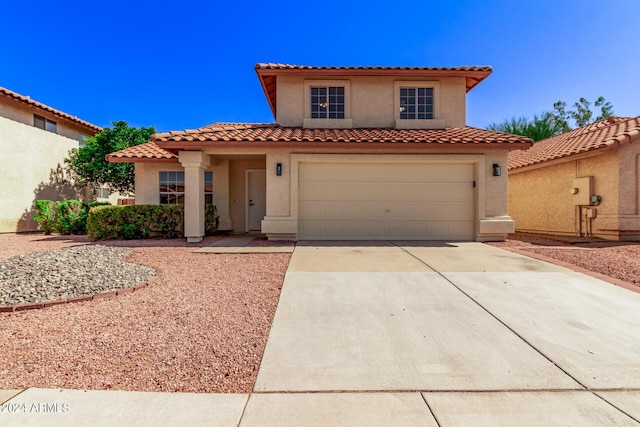 mediterranean / spanish-style home featuring a garage