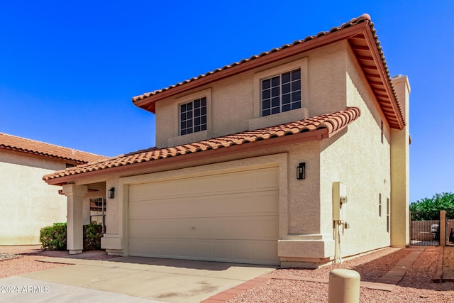 mediterranean / spanish house featuring a garage